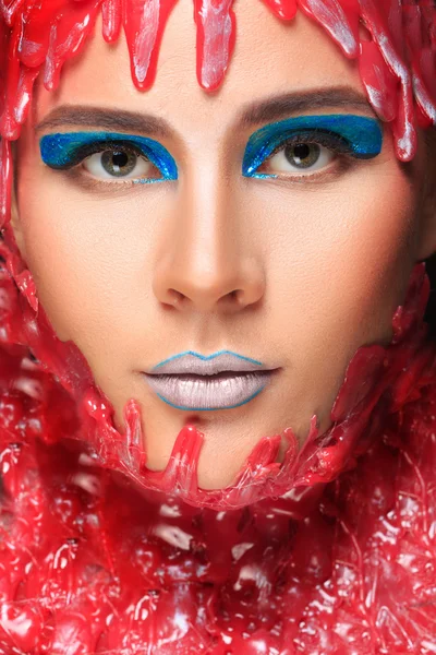 Portrait of a beautiful girl bathed in red wax — Stock Photo, Image