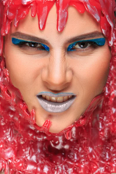 Portrait of a beautiful girl bathed in red wax — Stock Photo, Image