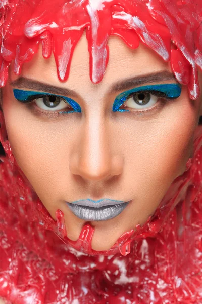 Portrait of a beautiful girl bathed in red wax — Stock Photo, Image