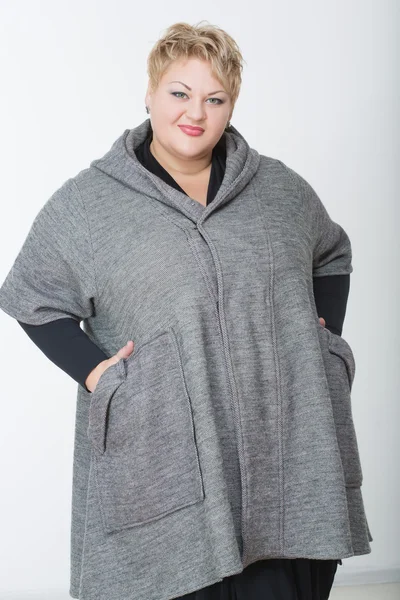 Thick charming woman in a gray coat — Stock Photo, Image