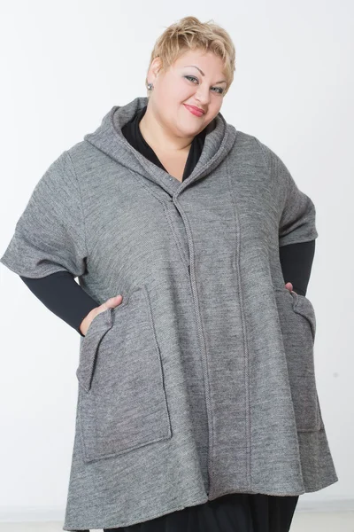 Thick charming woman in a gray coat — Stock Photo, Image