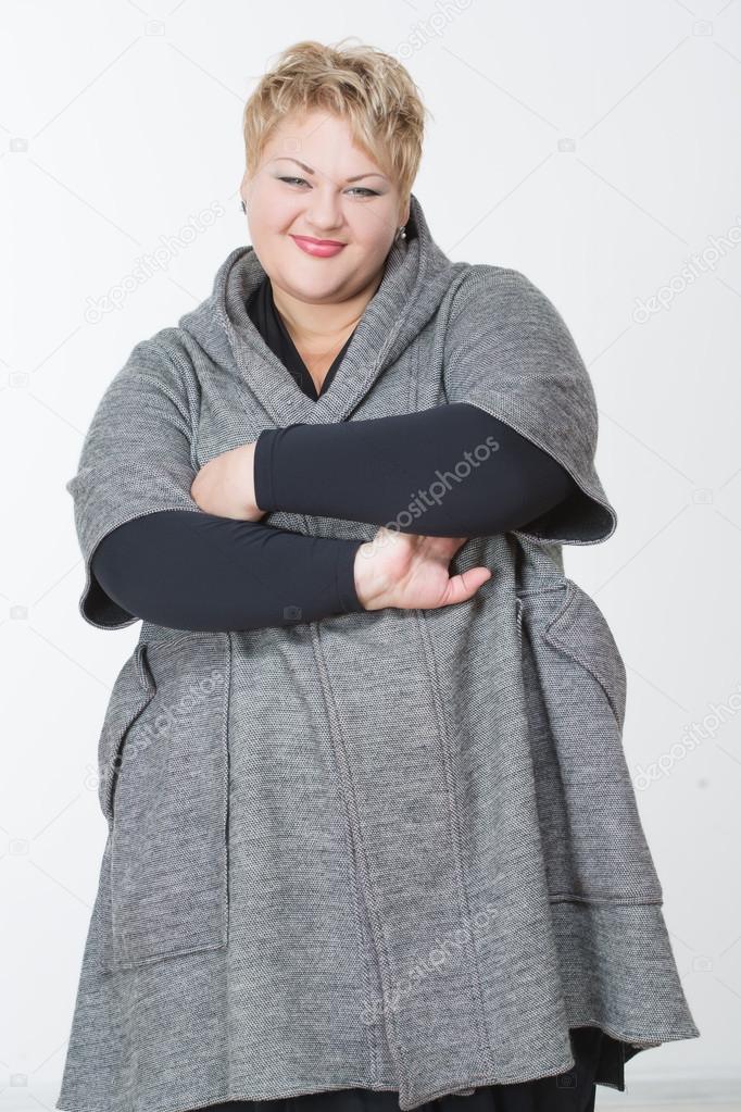 thick charming woman in a gray coat