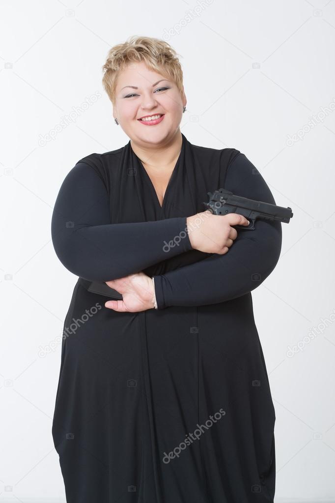 fat woman with a gun. in a black dress