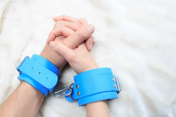 Male and female hands in handcuffs. sexy couple in bed. sex Toys — Stock Photo, Image