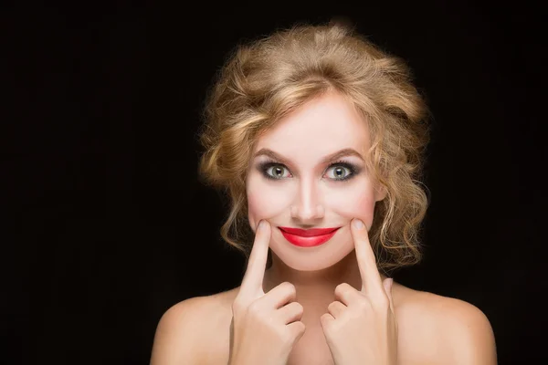 Girl pulls a smile fingers — Stock Photo, Image