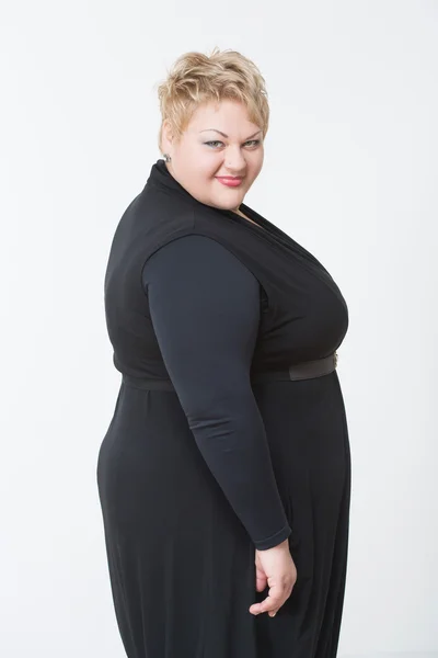 Smiling fat woman in black dress — Stock Photo, Image