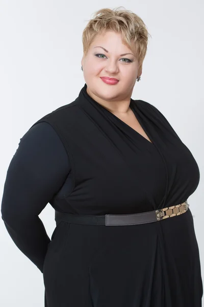 Smiling fat woman in black dress — Stock Photo, Image