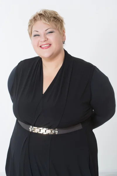 Smiling fat woman in black dress — Stock Photo, Image