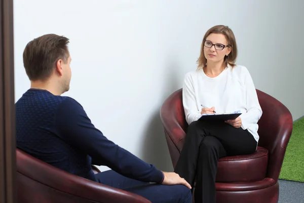 Psikolog berkonsultasi dengan pria termenung selama sesi terapi psikologis — Stok Foto