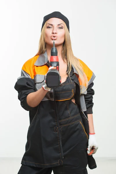 Young sexy female holding a cordless screwdriver — Stock Photo, Image