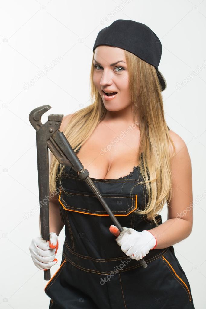 Young girl with a wrench in his hand.