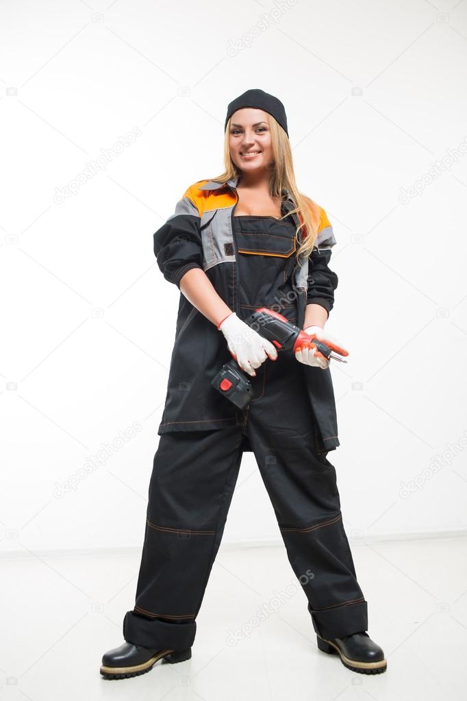 Young sexy female holding a cordless screwdriver