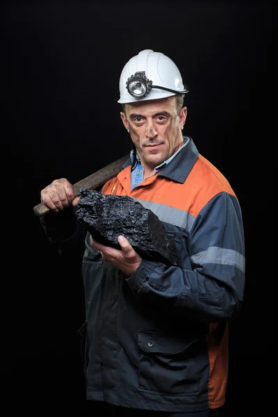 Coalminer holds out a large chunk of energy rich coal — стоковое фото