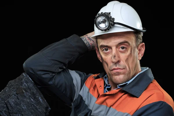 Coalminer holds out a large chunk of energy rich coal — стоковое фото