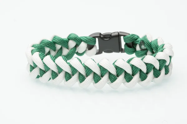 Green braided bracelet on white background — Stock Photo, Image