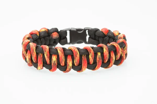 Black and orange braided bracelet on white background — Stock Photo, Image