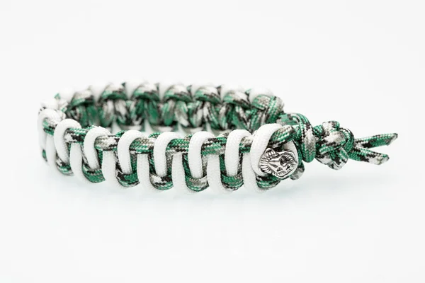 Green braided bracelet on white background — Stock Photo, Image