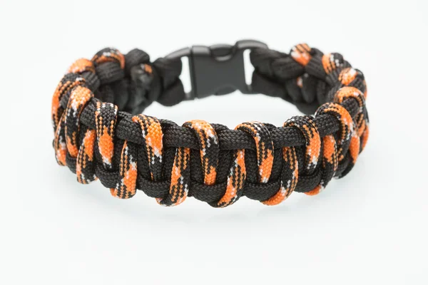 Black and orange braided bracelet on white background — Stock Photo, Image