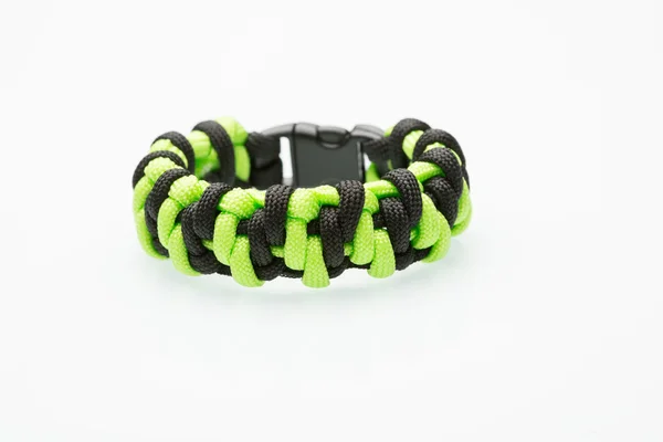 Green braided bracelet on white background — Stock Photo, Image