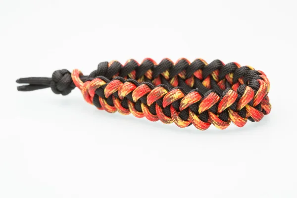 Black and orange braided bracelet on white background — Stock Photo, Image