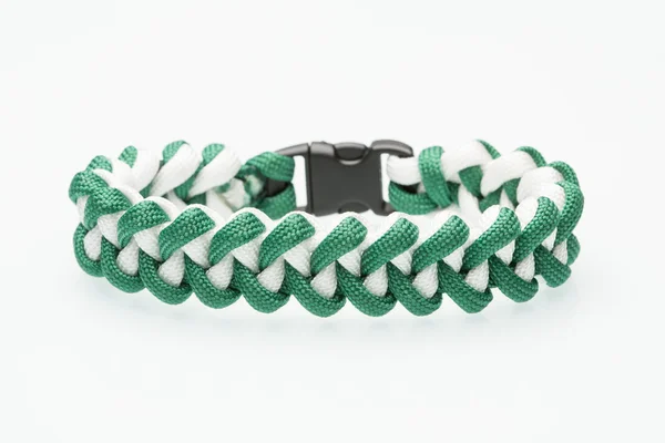 Green braided bracelet on white background — Stock Photo, Image