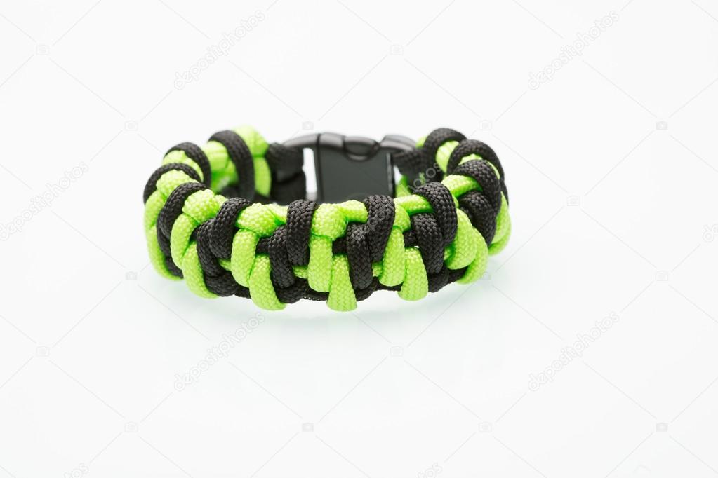 green braided bracelet on white background