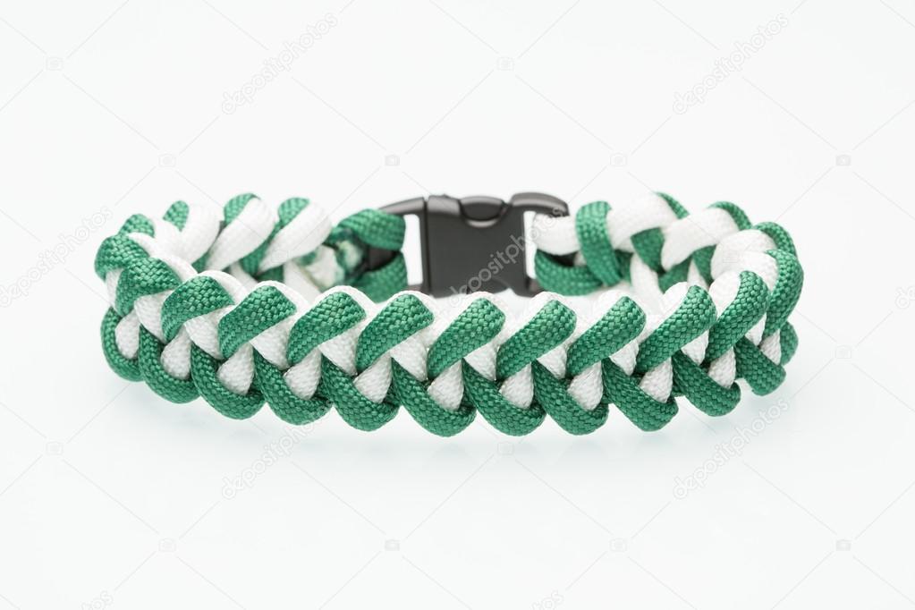 green braided bracelet on white background