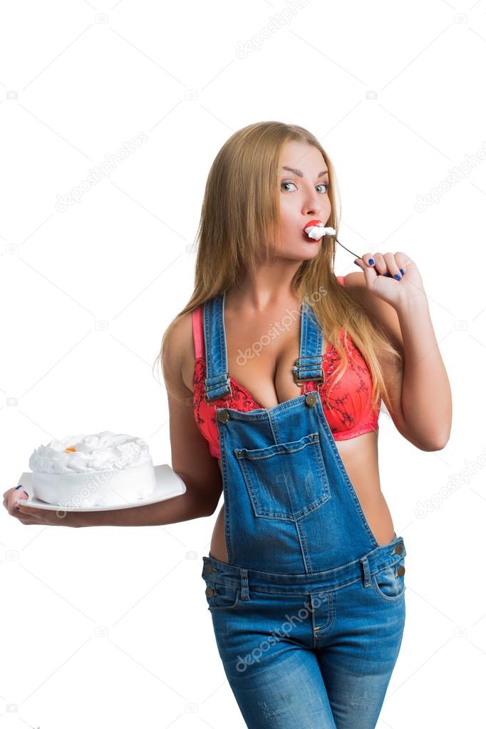 Busty sexy girl eating cake with whipped cream