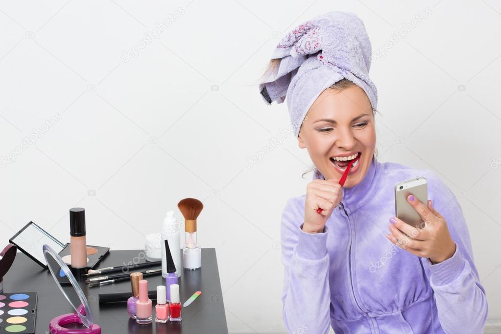 woman brushing her teeth and talking on the phone