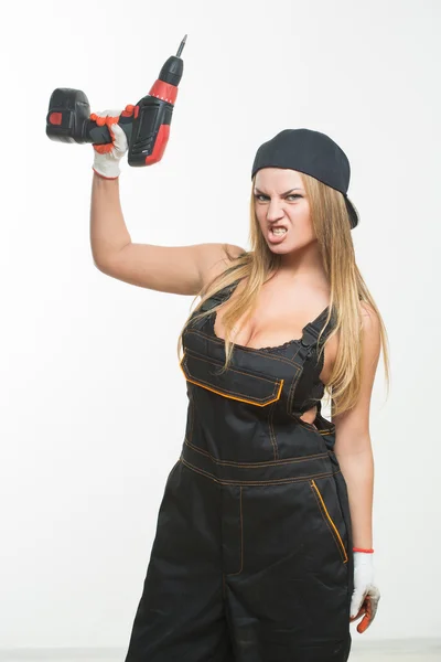 Young sexy female holding a cordless screwdriver — Stock Photo, Image