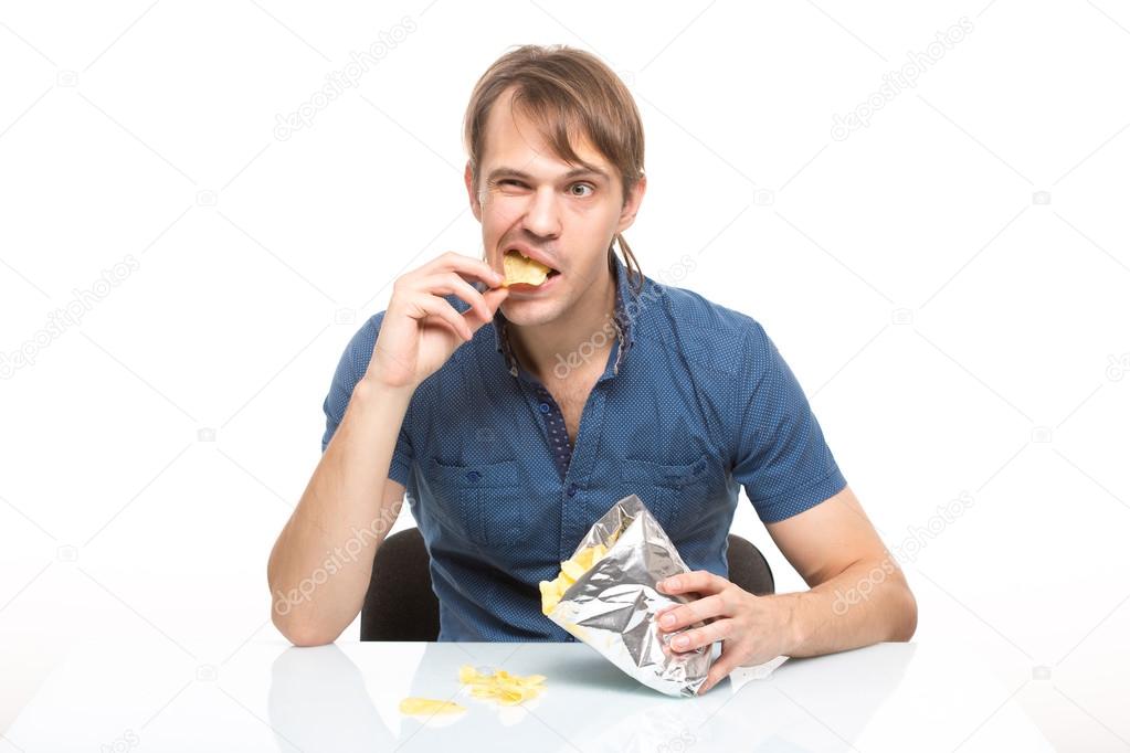 man scattered potato chips on the table