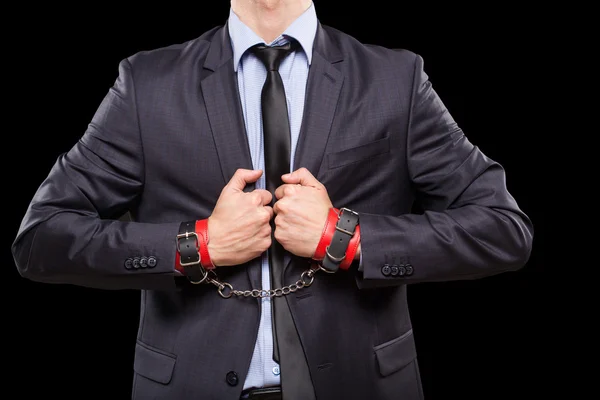 Man in a business suit with leather bound. handcuffs. sex Toys — Stock Photo, Image