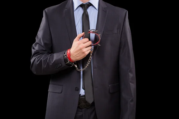 Man in a business suit with leather bound. handcuffs. sex Toys — Stock Photo, Image