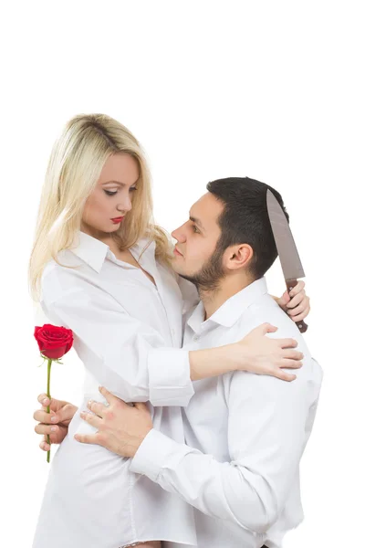 Girl holding knife traitor. man with rose in his hand. white background — Stock Photo, Image