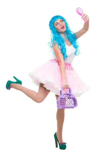Young girl doll with blue hair. holding a mirror and handbag — Stock Photo, Image