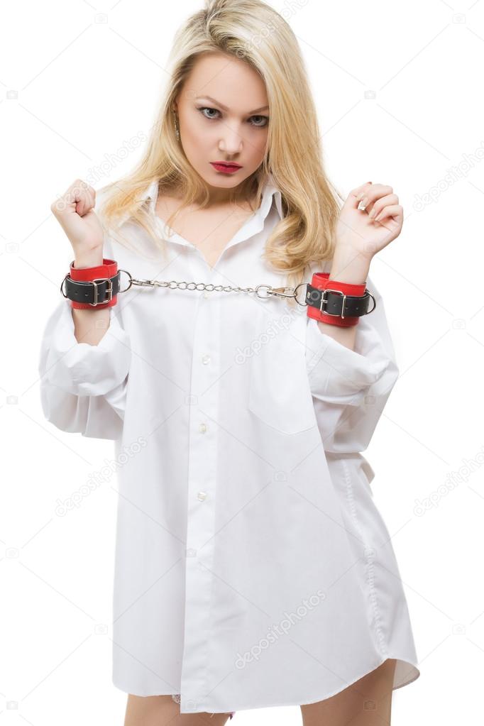 woman in a mans shirt handcuffed. Isolated on white background, sex toy