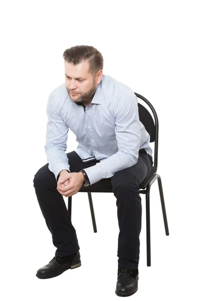 Man sitting on chair. Isolated white background. makes decisions. aggressive. clenched fist — Stock Photo, Image