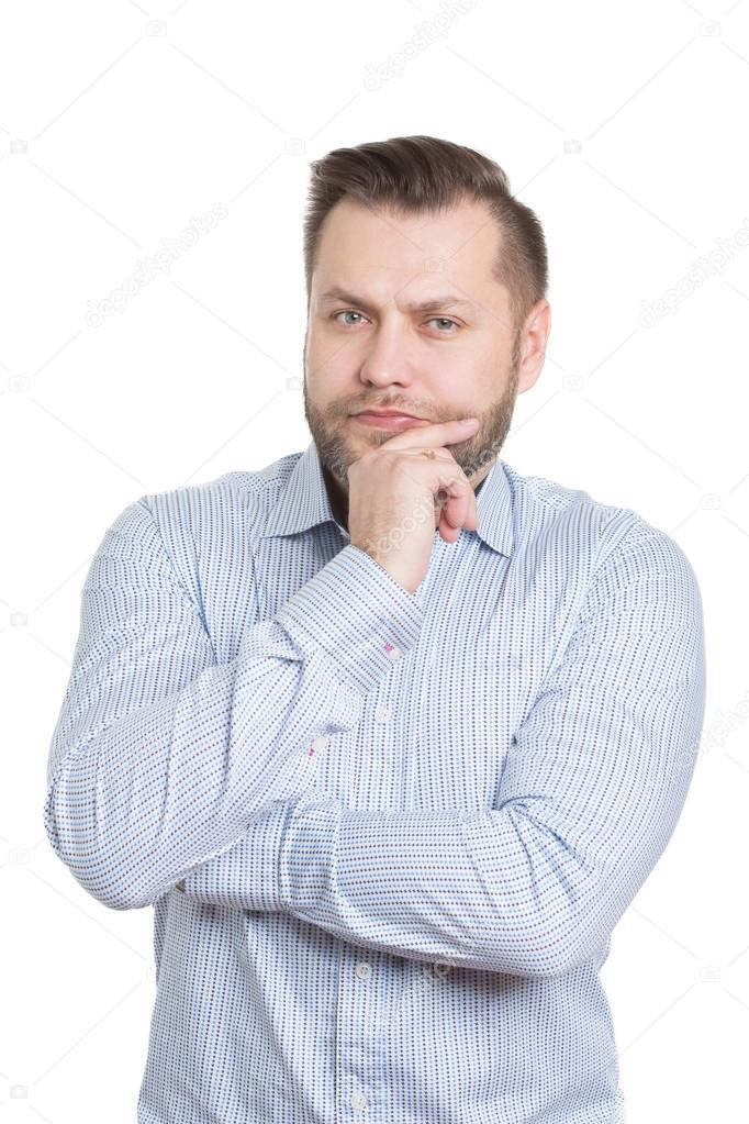 adult male with a beard. isolated on white background. finger under his chin. gestures thought. decision