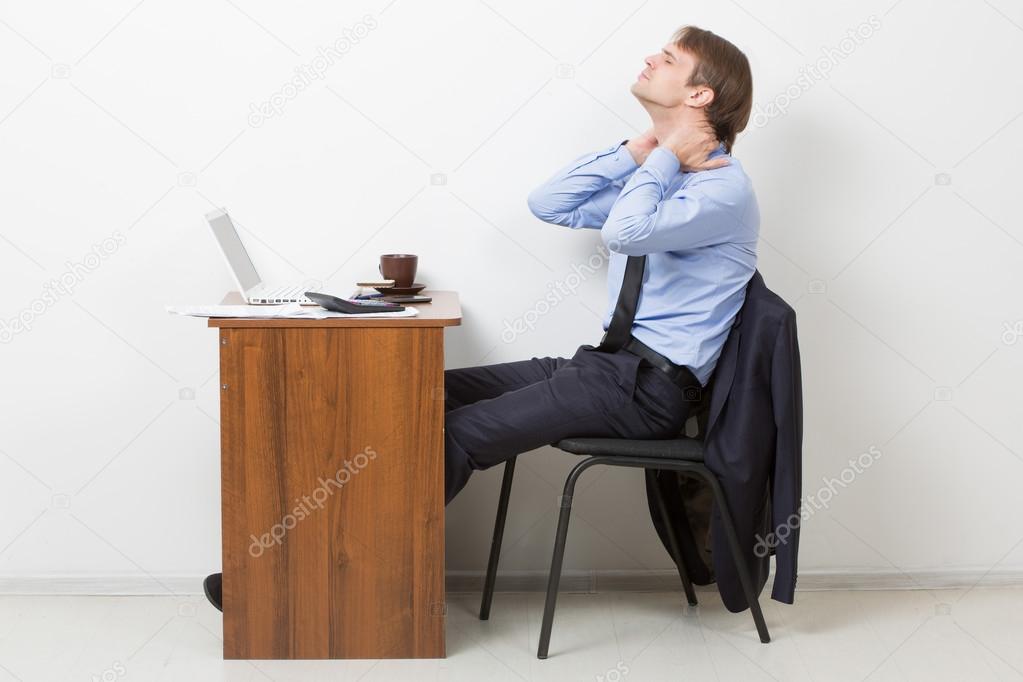 Businessman Using Computer Suffering From Neck Ache