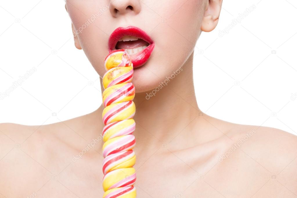 Close-up shot of womans mouth bright red lips with lollipop. blowjob simulation