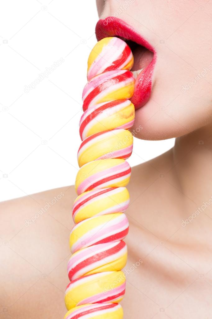 Close-up shot of womans mouth bright red lips with lollipop. blowjob simulation