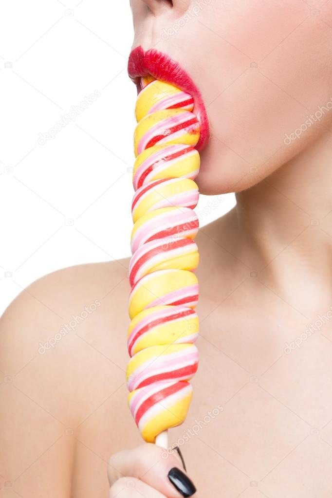 Close-up shot of womans mouth bright red lips with lollipop. blowjob simulation