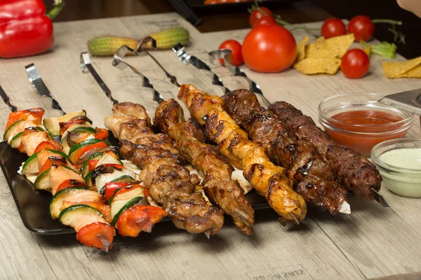 Set shashlik. kebab skewer, black rectangular plate. sauce and onions — Stock Photo, Image