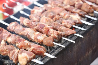 Grilling marinated shashlik on a grill. Shish kebab popular in Eastern, Central Europe and other places.
