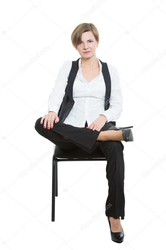 Woman sits a chair. legs crossed, hand in the crotch. misses. dominant