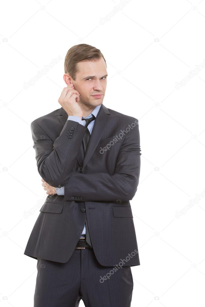 body language. man in business suit isolated white background. scratching, rubbing the ear. gesture of distrust speaker