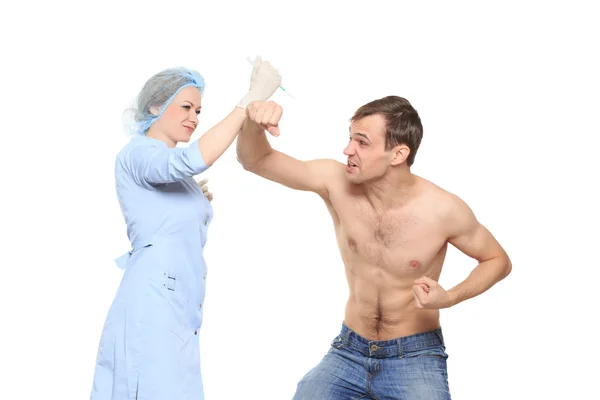 Woman doctor puts a prick. The man is afraid and feels panic. Isolated on white background. man does not set yourself an injection. woman doctor — Stok fotoğraf