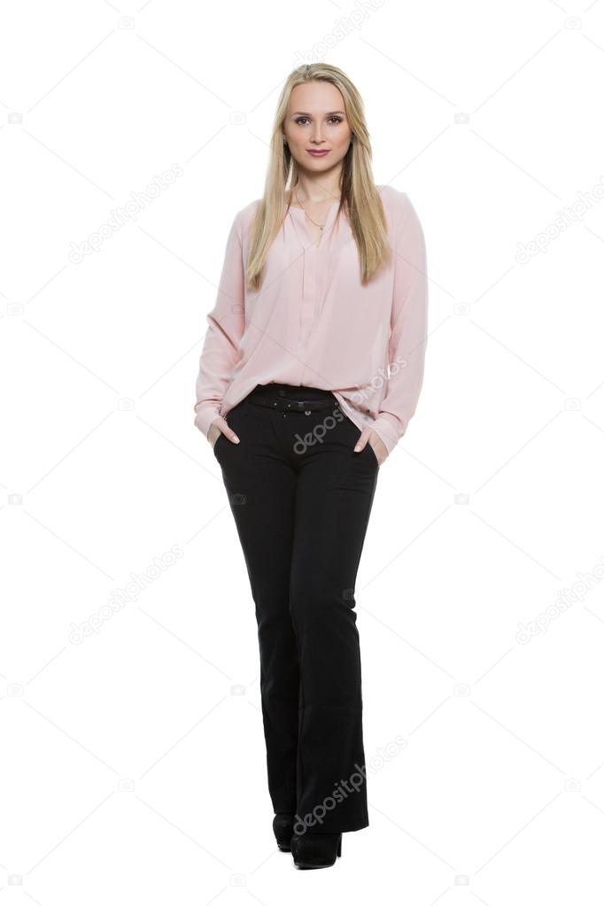 exhibiting thumbs. girl standing with feet together. knees pressed. Isolated on white background. body language