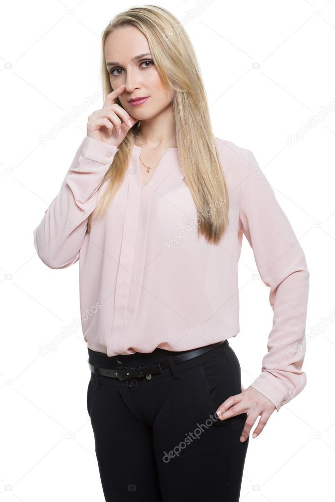 girl in pants and blous.  Isolated on white background. body language. fingers face. gesture lies. touching the hands to the face, touching the nose.