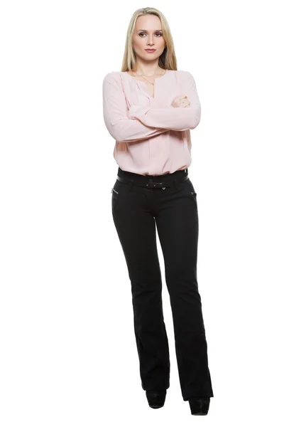 Girl in pants and blous.  Isolated on white background. body language. legs wide apart, arms crossed on his chest. standard gesture — Stockfoto